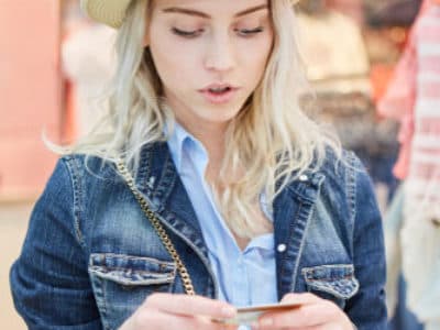 Female looking at RFID loyalty card in hand