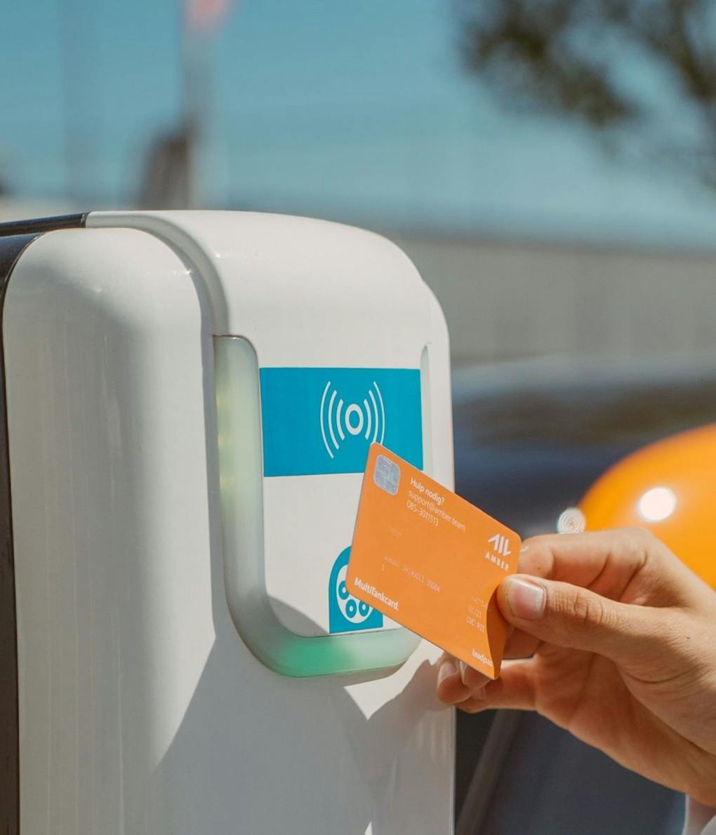 Hand tapping an RFID EV Charge Card against a charging point
