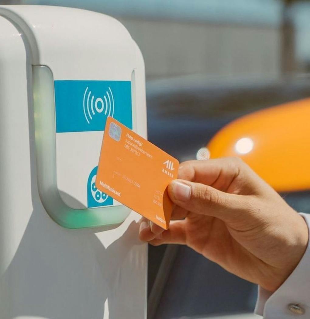 Man holding RFID EV charge card against chargepoint
